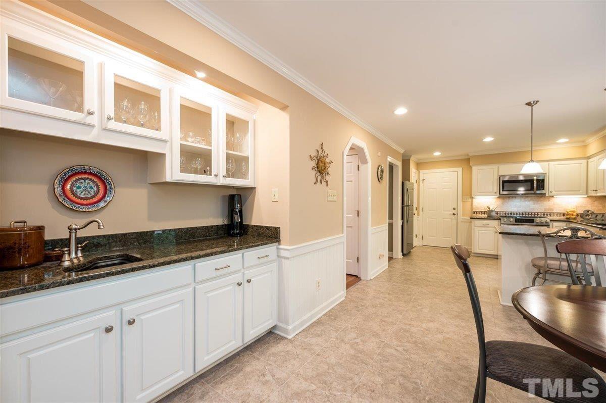 7916 Sutterton Court Raleigh, NC 27615 - Photo 10 of 25 a kitchen with stainless steel appliances granite countertop a sink and cabinets