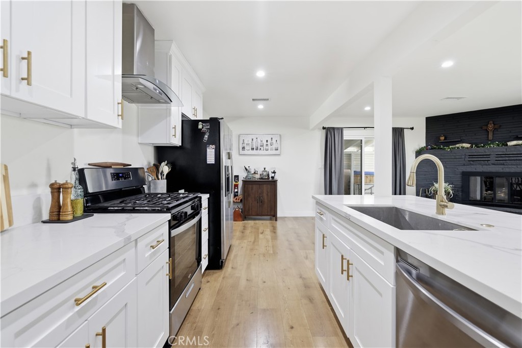44335 Glenraven Road Lancaster, CA 93535 - Photo 11 of 32 a kitchen with stainless steel appliances granite countertop a sink and cabinets