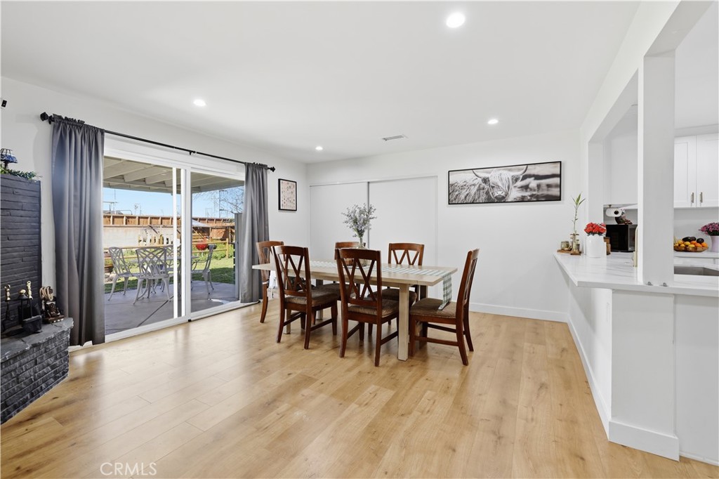 44335 Glenraven Road Lancaster, CA 93535 - Photo 13 of 32 a dining room with furniture and wooden floor