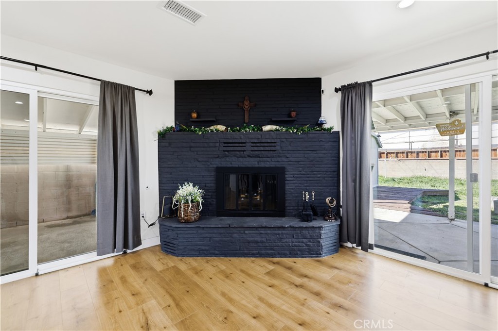 44335 Glenraven Road Lancaster, CA 93535 - Photo 14 of 32 a living room with fireplace and a table