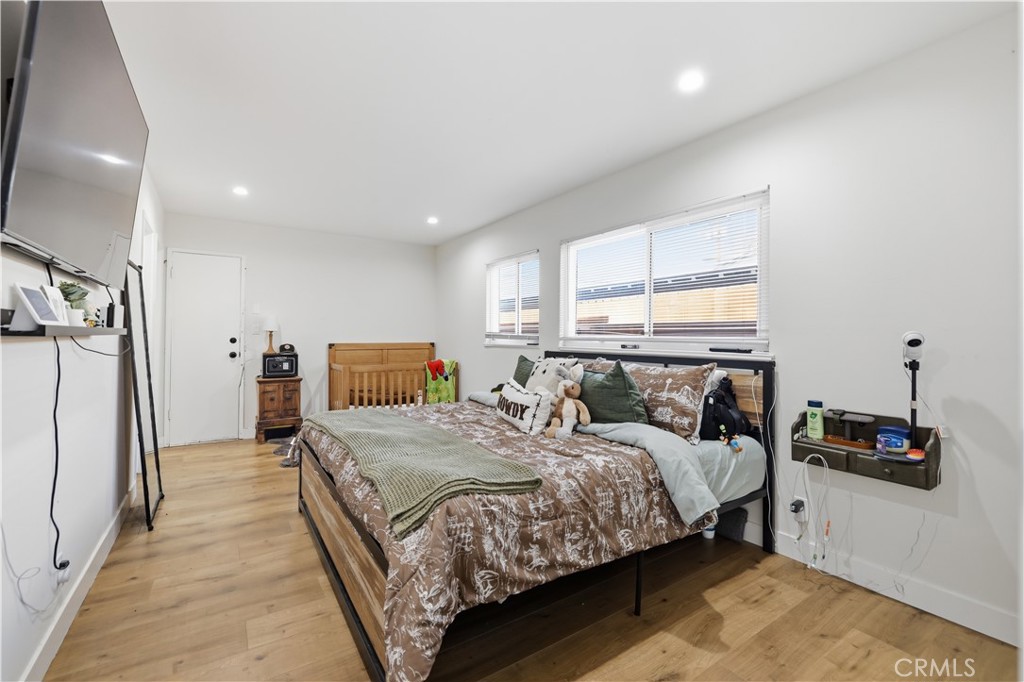 44335 Glenraven Road Lancaster, CA 93535 - Photo 18 of 32 a bedroom with a bed and a flat tv screen on a dresser