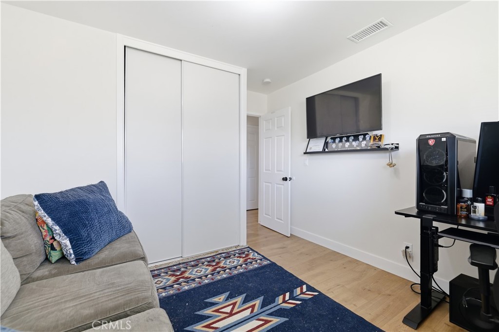 44335 Glenraven Road Lancaster, CA 93535 - Photo 22 of 32 a living room with furniture and a flat screen tv