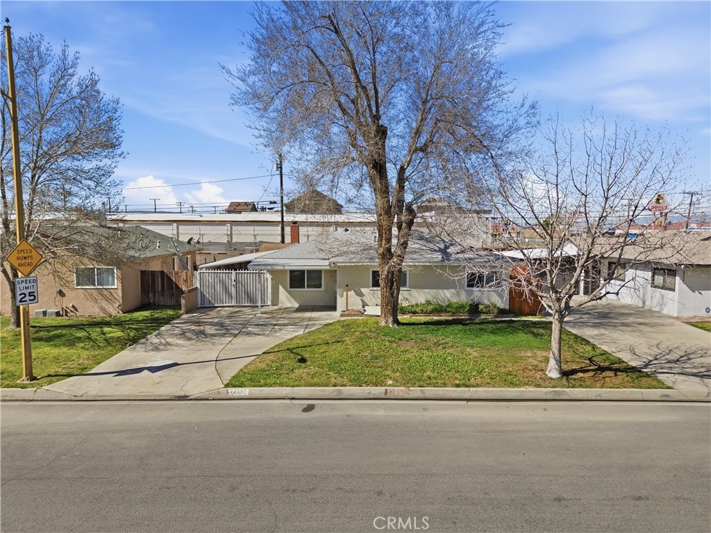 44335 Glenraven Road Lancaster, CA 93535 - Photo 30 of 32 a view of a house with a yard and large trees