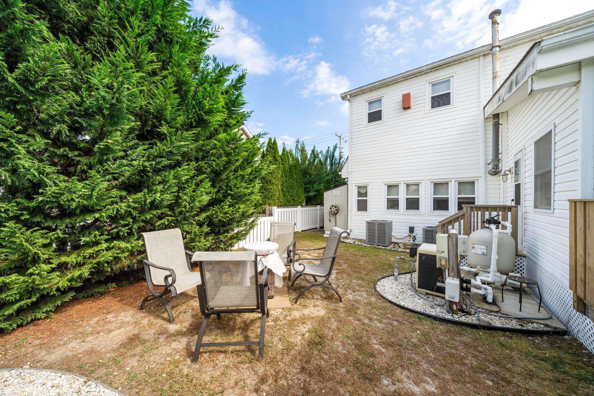 2754 1st Avalon, NJ 08202 - Photo 25 of 26 a view of a patio with table and chairs and potted plants