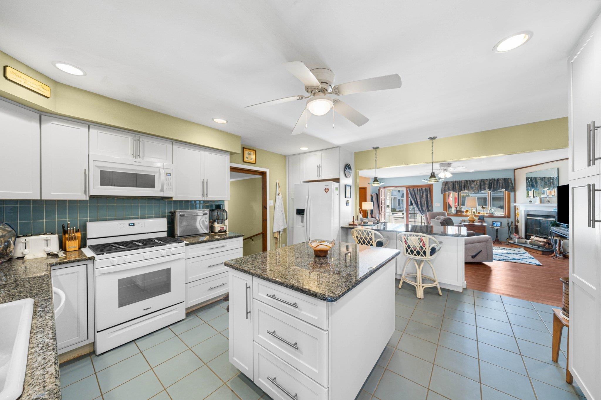 2754 1st Avalon, NJ 08202 - Photo 4 of 26 a kitchen with a stove a sink dishwasher and a refrigerator with wooden floor