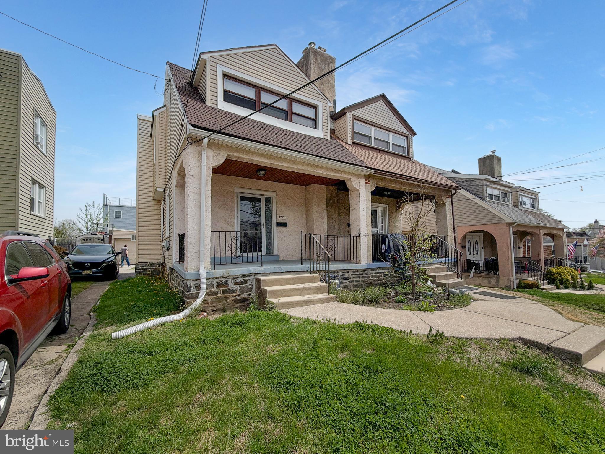 a view of a big house with a big yard and large tree