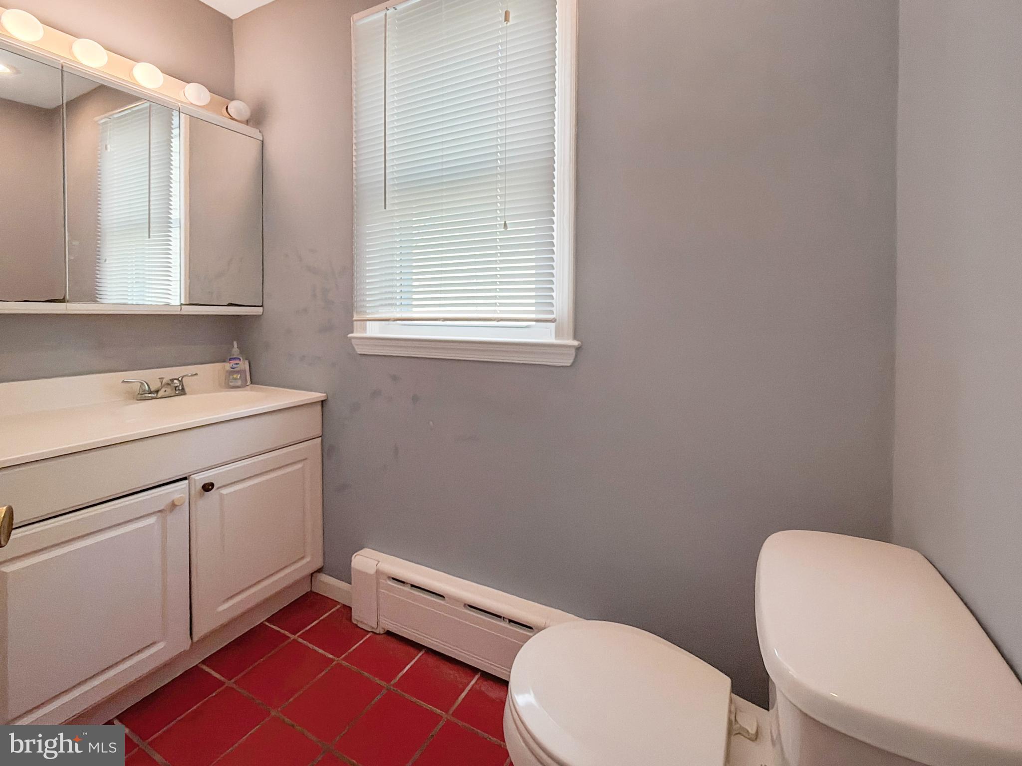 1213 Harding Drive Havertown, PA 19083 - Photo 16 of 25 a bathroom with a toilet a sink and a mirror