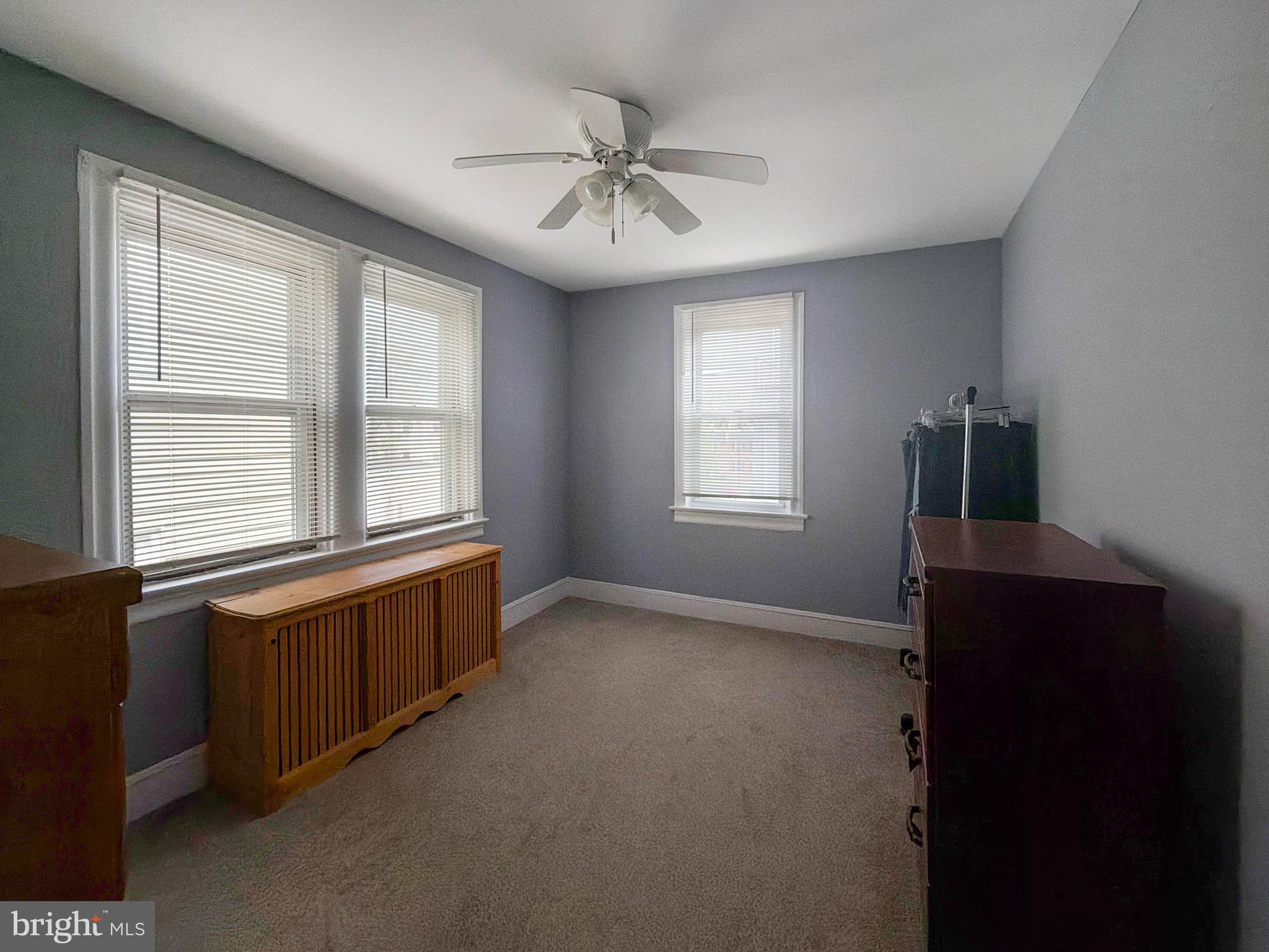 1213 Harding Drive Havertown, PA 19083 - Photo 19 of 25 an empty room with chandelier fan and windows