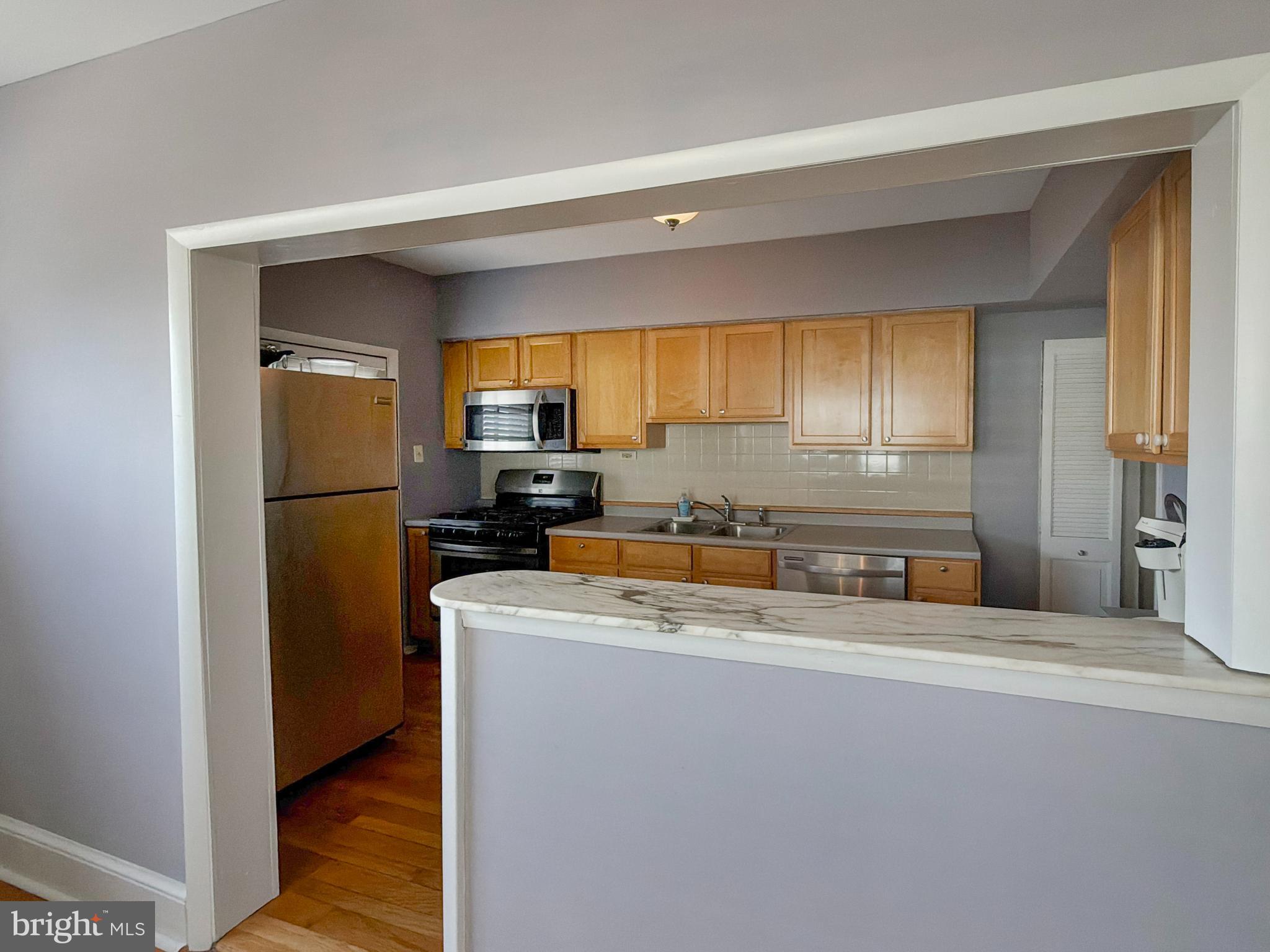 1213 Harding Drive Havertown, PA 19083 - Photo 8 of 25 a kitchen with a refrigerator a sink and a stove