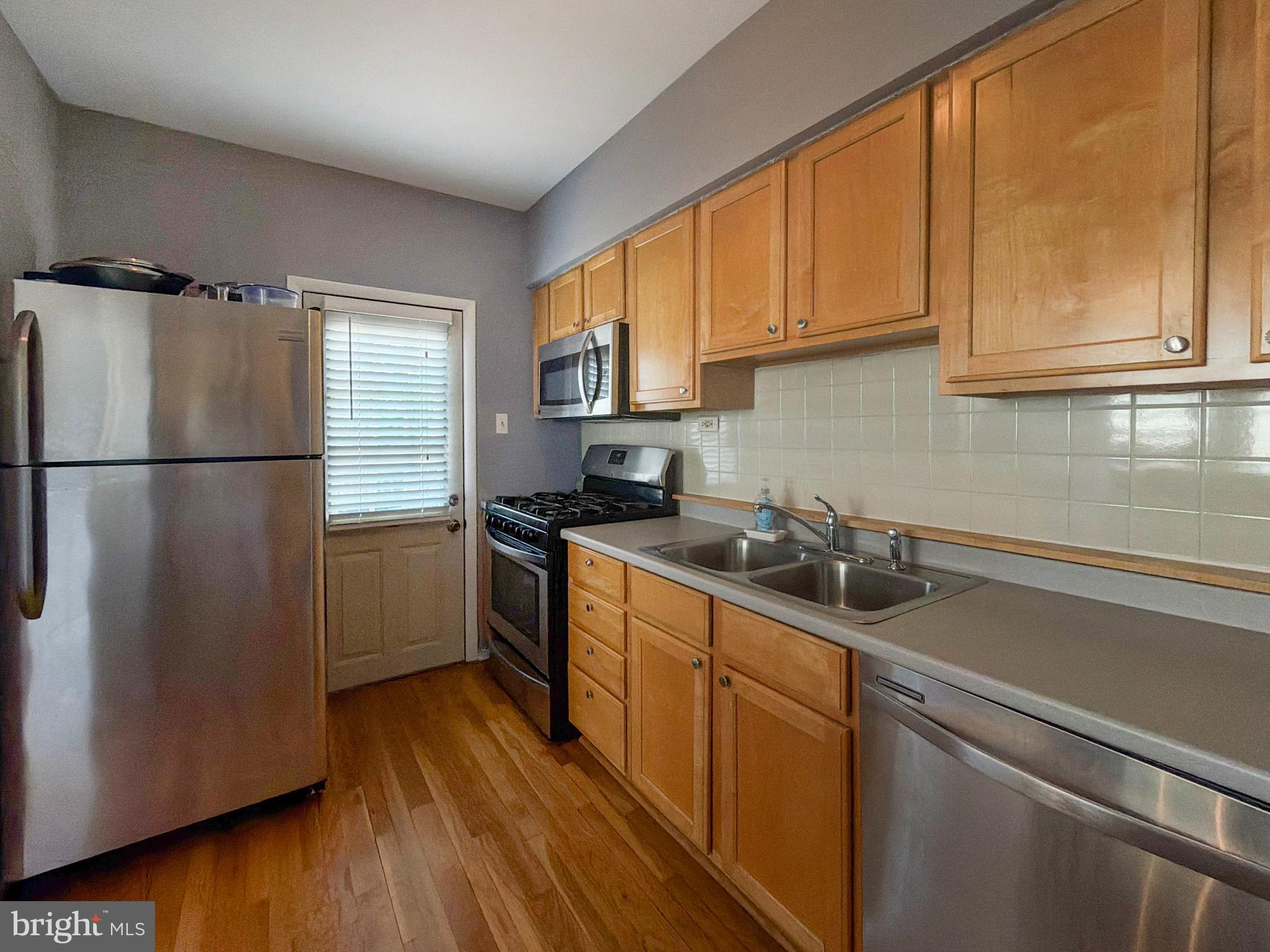 1213 Harding Drive Havertown, PA 19083 - Photo 9 of 25 a kitchen with a refrigerator sink and cabinets