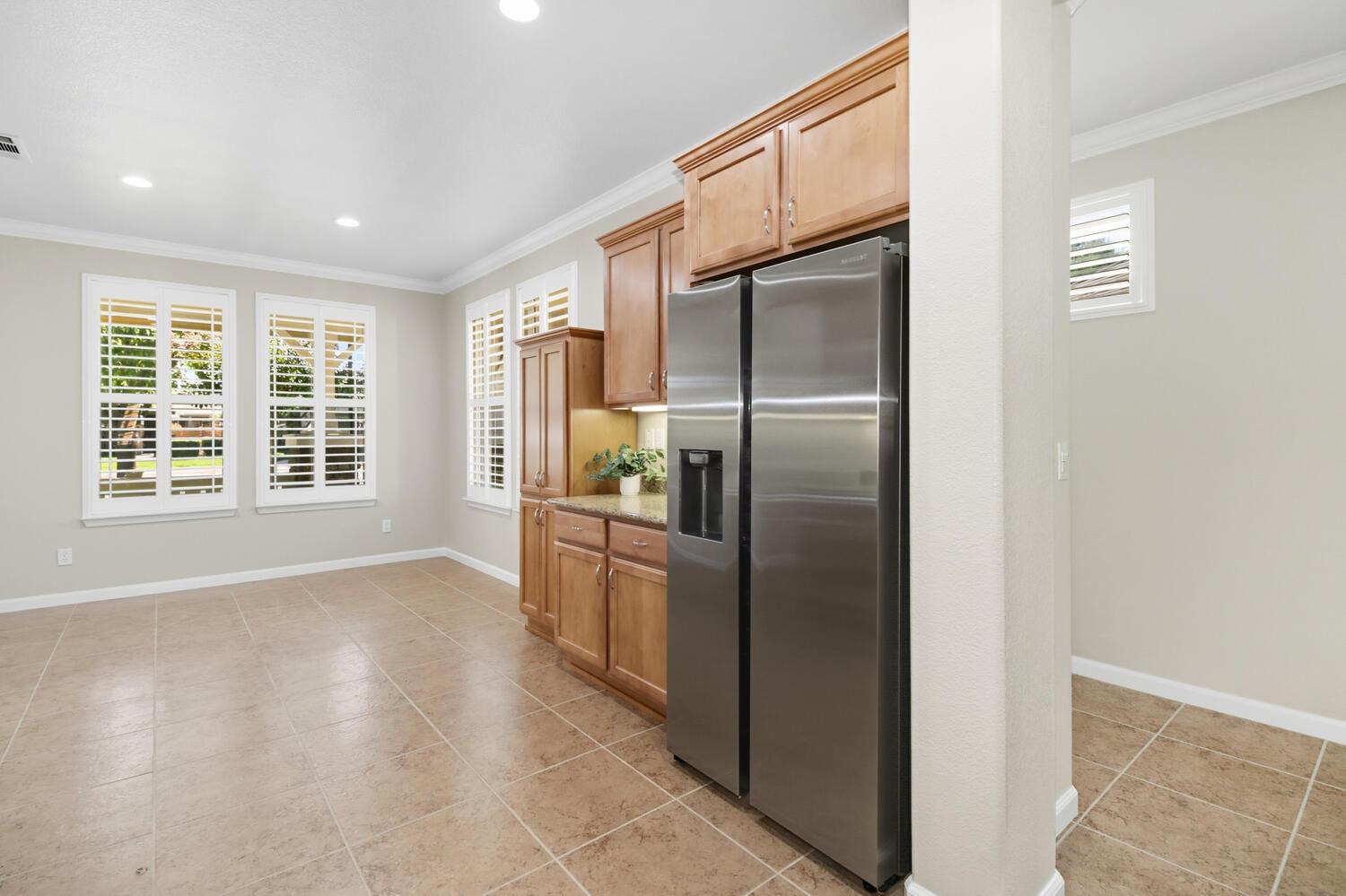 7409 Rothschild Court Elk Grove, CA 95757 - Photo 14 of 62 a kitchen with stainless steel appliances granite countertop a refrigerator and a sink