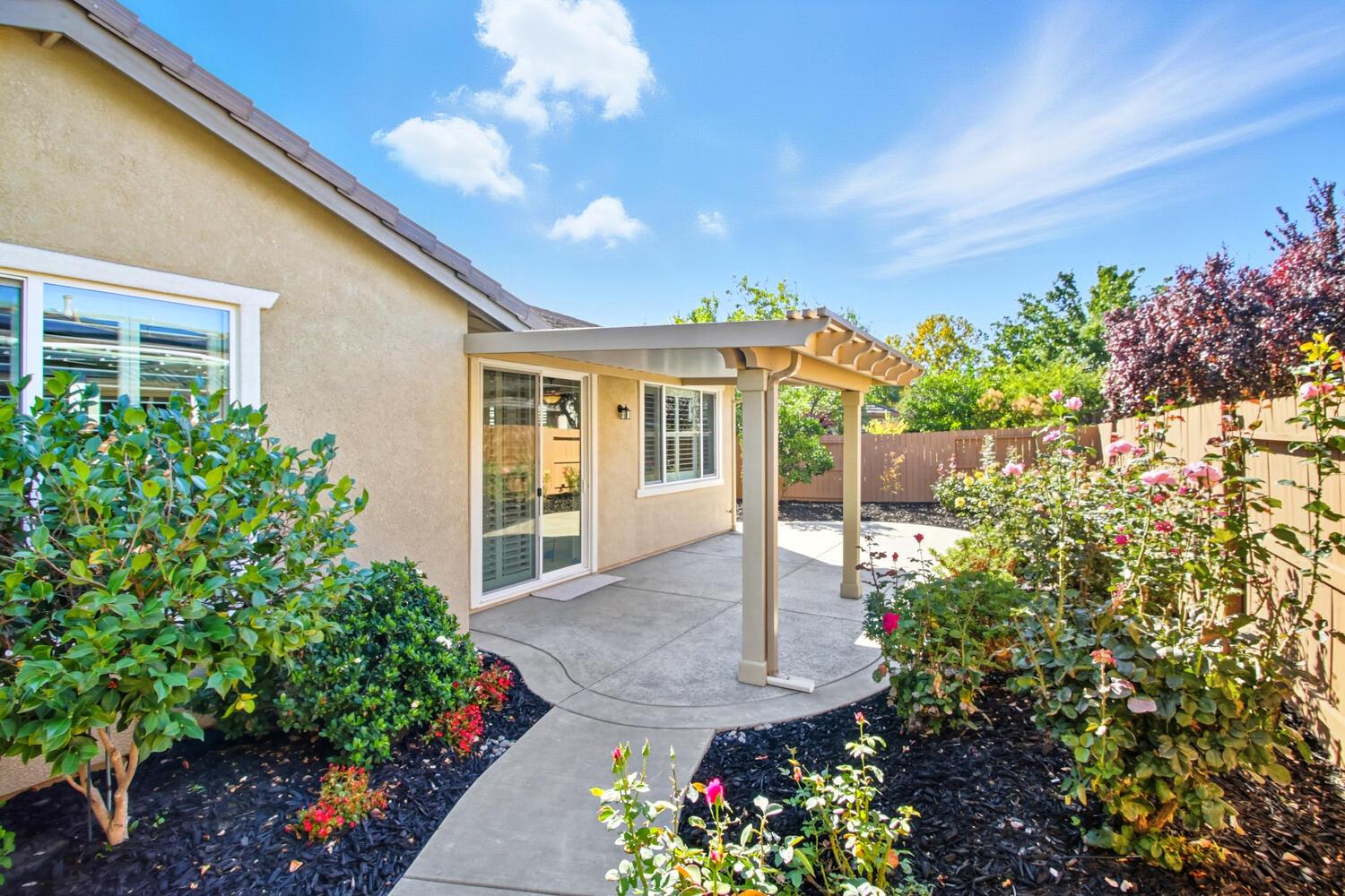 7409 Rothschild Court Elk Grove, CA 95757 - Photo 40 of 62 a front view of a house with a yard