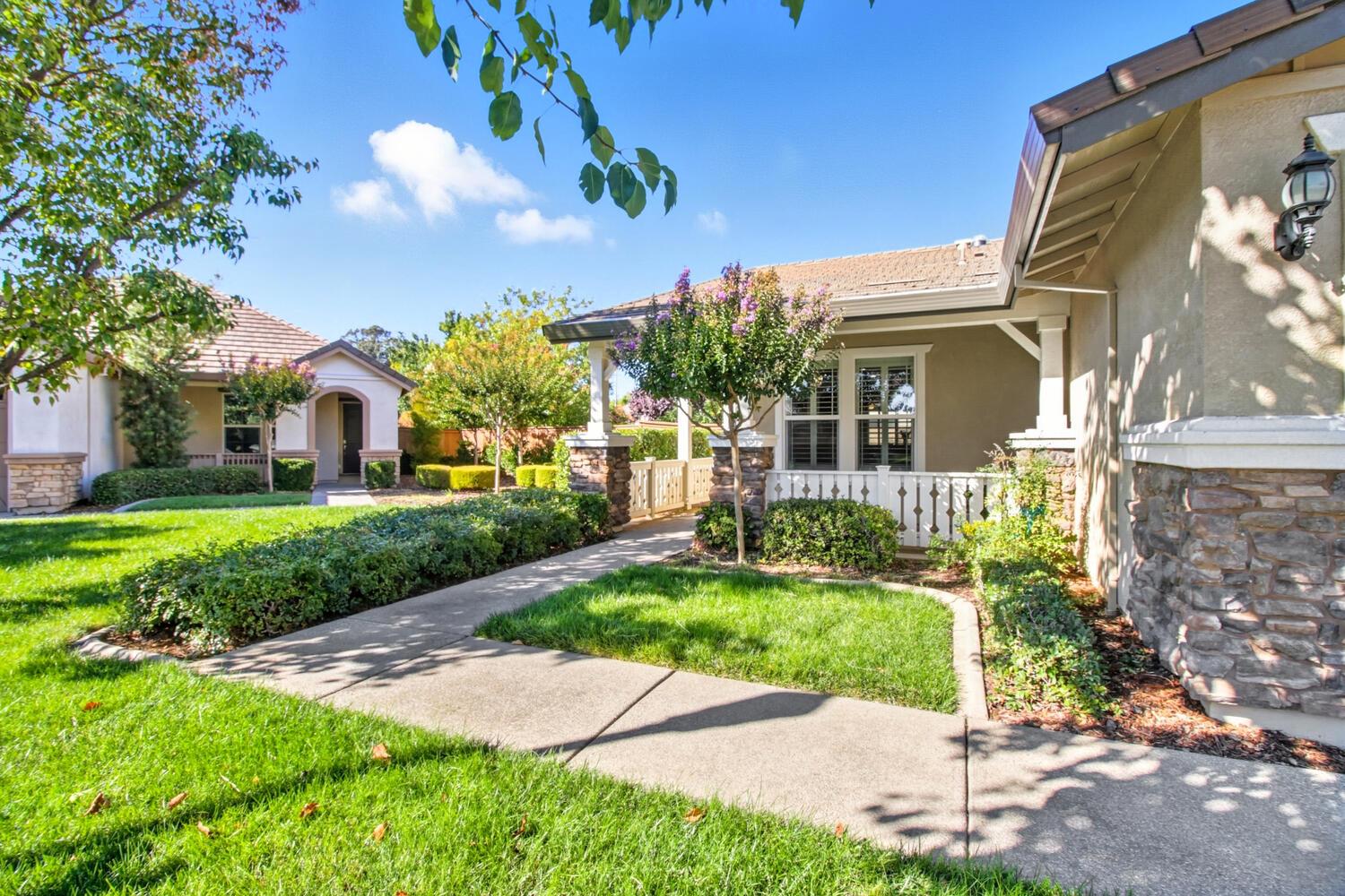 7409 Rothschild Court Elk Grove, CA 95757 - Photo 4 of 62 a view of a white house with a yard and plants