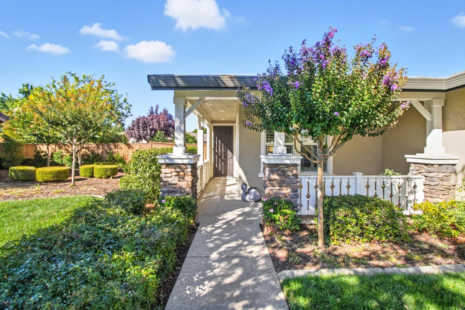 7409 Rothschild Court Elk Grove, CA 95757 - Photo 5 of 62 a front view of a house with a yard and fountain