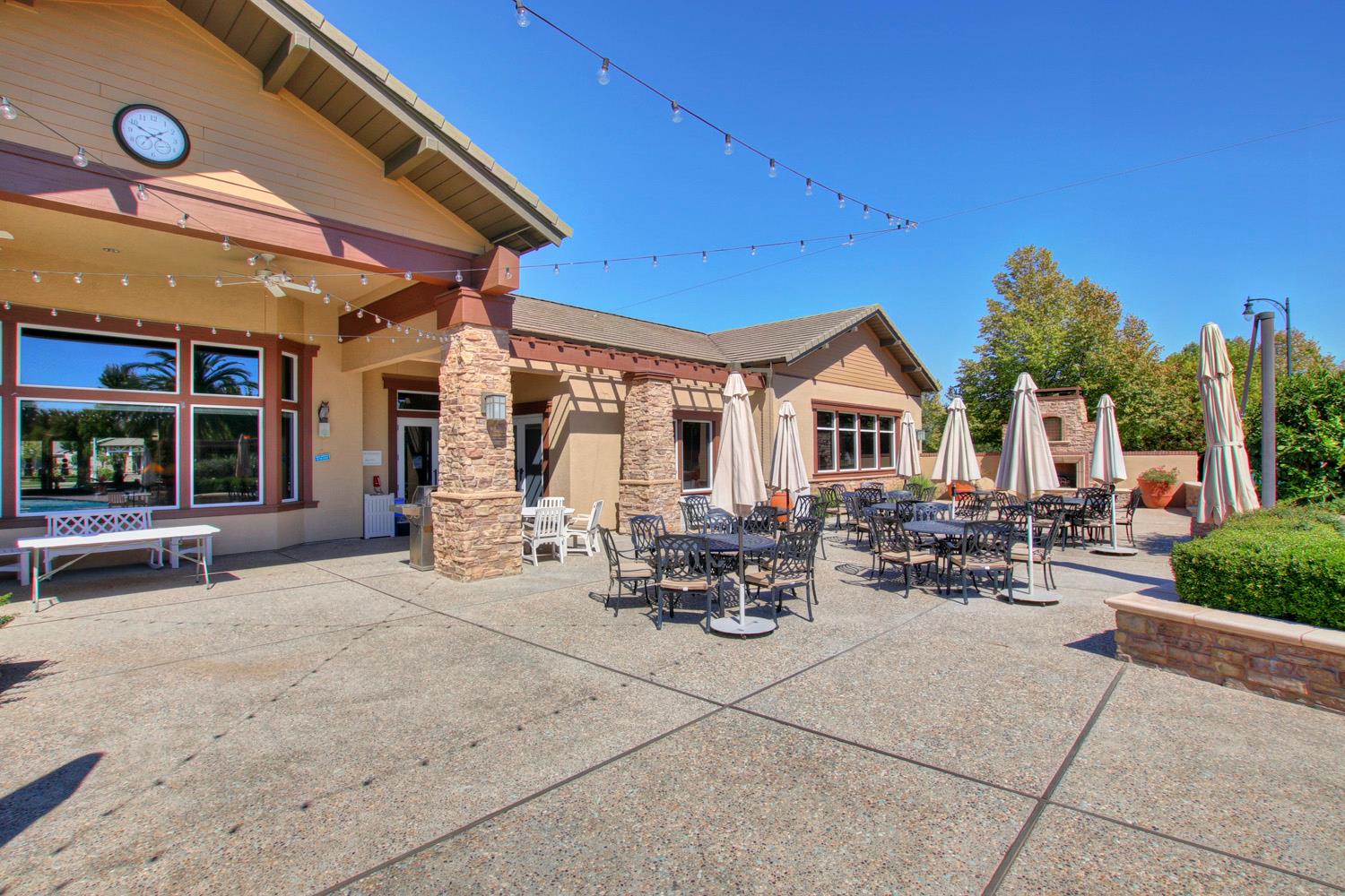 7409 Rothschild Court Elk Grove, CA 95757 - Photo 52 of 62 a view of a patio with dining table and chairs under an umbrella