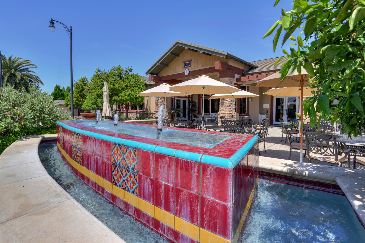 7409 Rothschild Court Elk Grove, CA 95757 - Photo 55 of 62 a roof deck with a table and chairs under an umbrella