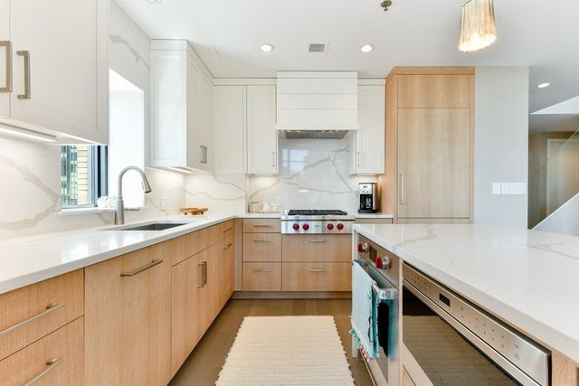 a kitchen with a sink stove and cabinets