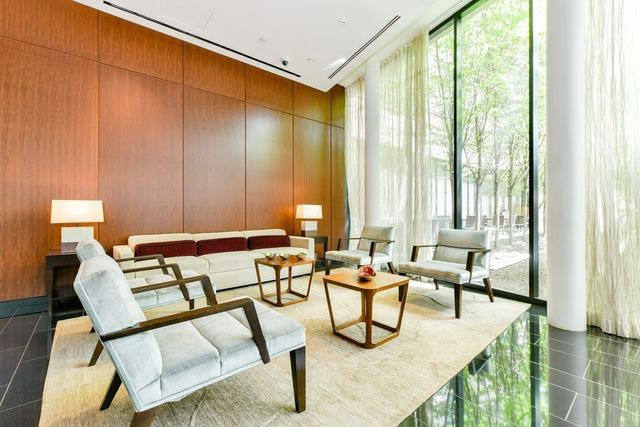 a view of a dining room with furniture and a chandelier