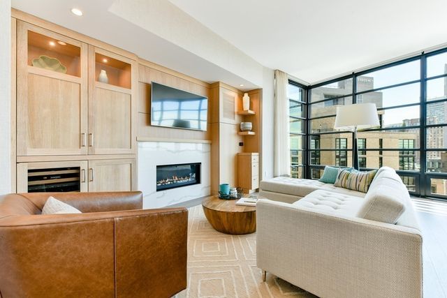 a living room with furniture fireplace and flat screen tv