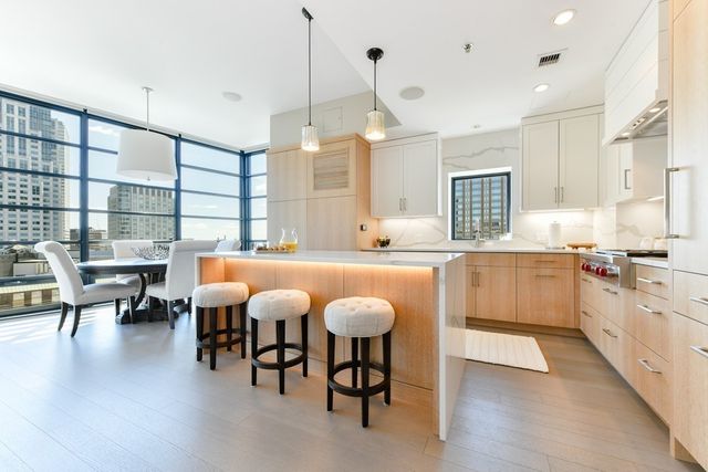 a large kitchen with a table and chairs