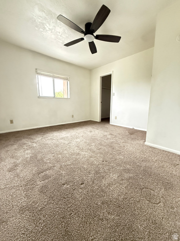 460 200 South Provo, UT 84606 - Photo 50 of 66 Spacious room featuring neutral carpeting, white walls, a multi-pane window, and a five-blade ceiling fan with integrated lighting