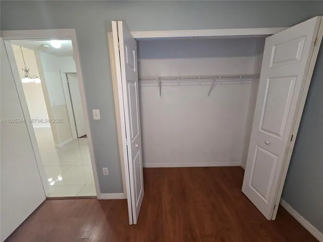 a view of room with window and air conditioner