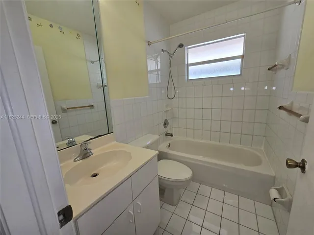 an empty room with wooden floor and entrance