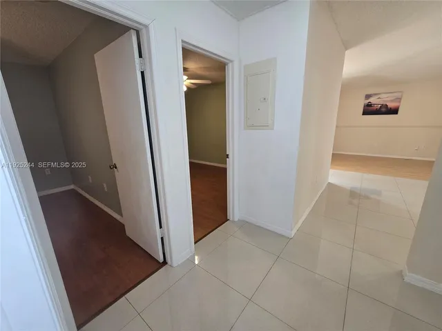 a view of empty room with wooden floor