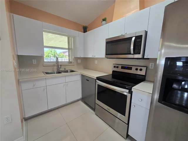 a kitchen with a stove and a microwave