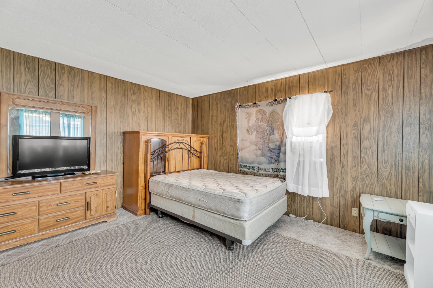 3901 Lake Road, Unit 92 West Sacramento, CA 95691 - Photo 14 of 26 a spacious bedroom with a bed and a flat screen television