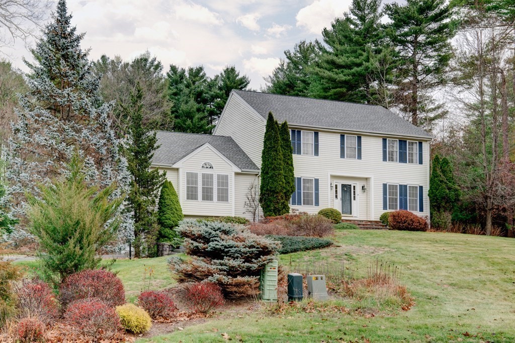 97 Weldon Farm Road Rowley, MA 01969 - Photo 1 of 37 a front view of a house with a yard and trees