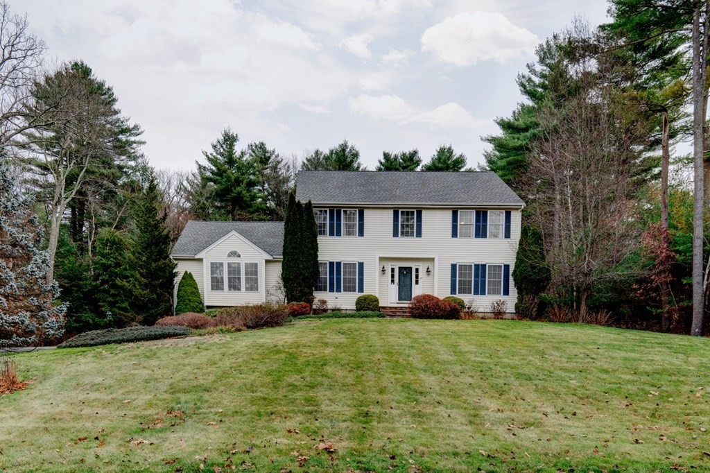 97 Weldon Farm Road Rowley, MA 01969 - Photo 2 of 37 a front view of a house with a yard table and trees