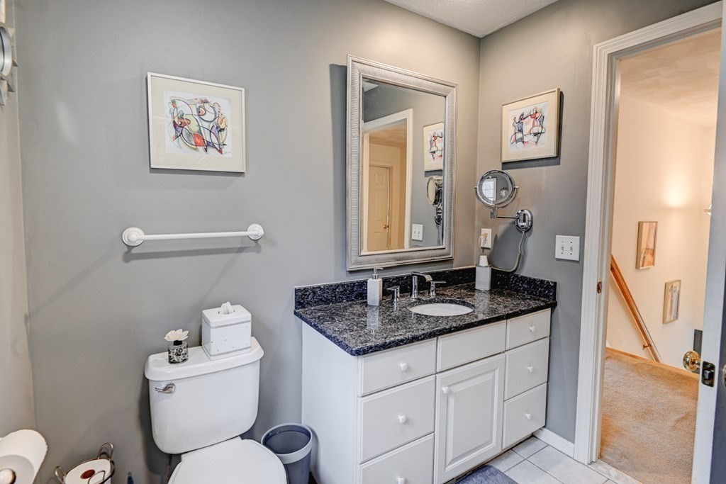 97 Weldon Farm Road Rowley, MA 01969 - Photo 28 of 37 a bathroom with a granite countertop toilet sink and mirror