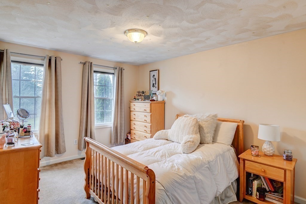 97 Weldon Farm Road Rowley, MA 01969 - Photo 30 of 37 a bedroom with a bed and wooden floor