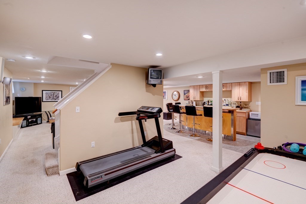 97 Weldon Farm Road Rowley, MA 01969 - Photo 35 of 37 a room with gym equipment and view of living room