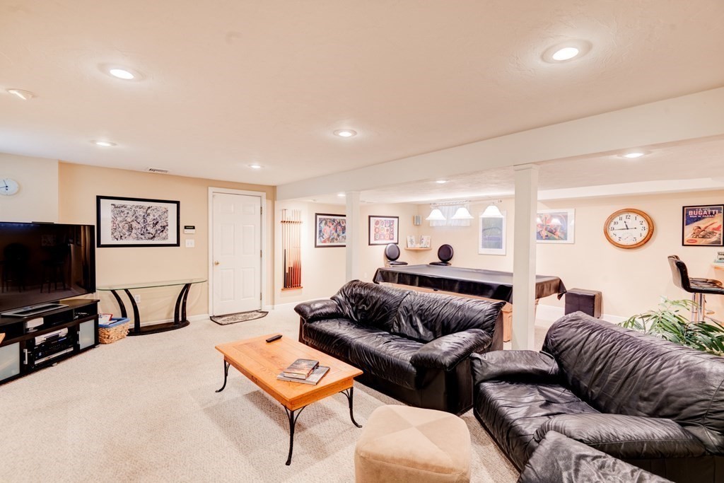 97 Weldon Farm Road Rowley, MA 01969 - Photo 36 of 37 a living room with furniture and a flat screen tv