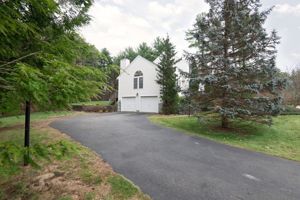 97 Weldon Farm Road Rowley, MA 01969 - Photo 4 of 37 a view of a house with a yard and large trees