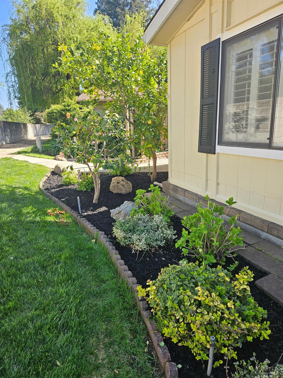2 San Ardo Court St. Helena, CA 94574 - Photo 27 of 45 a garden with a bench in front of the house