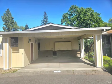 a view of a swimming pool with a patio and a yard