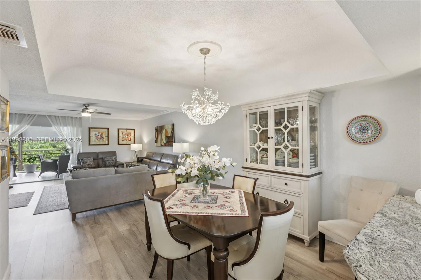 9170 Southwest 14th Street, Unit 4508 Boca Raton, FL 33428 - Photo 11 of 48 a living room with furniture chandelier and a table