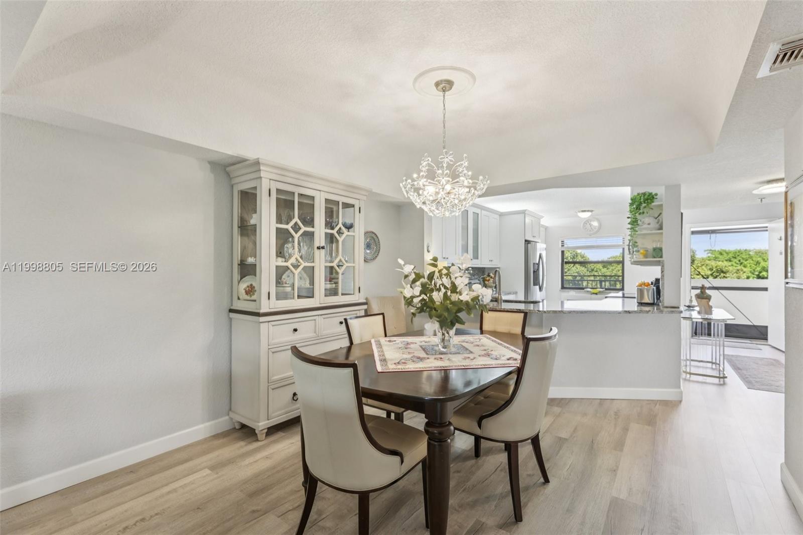 9170 Southwest 14th Street, Unit 4508 Boca Raton, FL 33428 - Photo 12 of 48 a view of a dining room with furniture and wooden floor