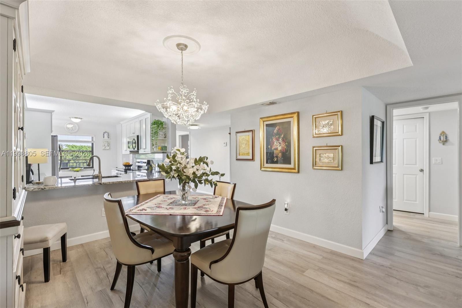 9170 Southwest 14th Street, Unit 4508 Boca Raton, FL 33428 - Photo 13 of 48 a view of a dining room with furniture and wooden floor