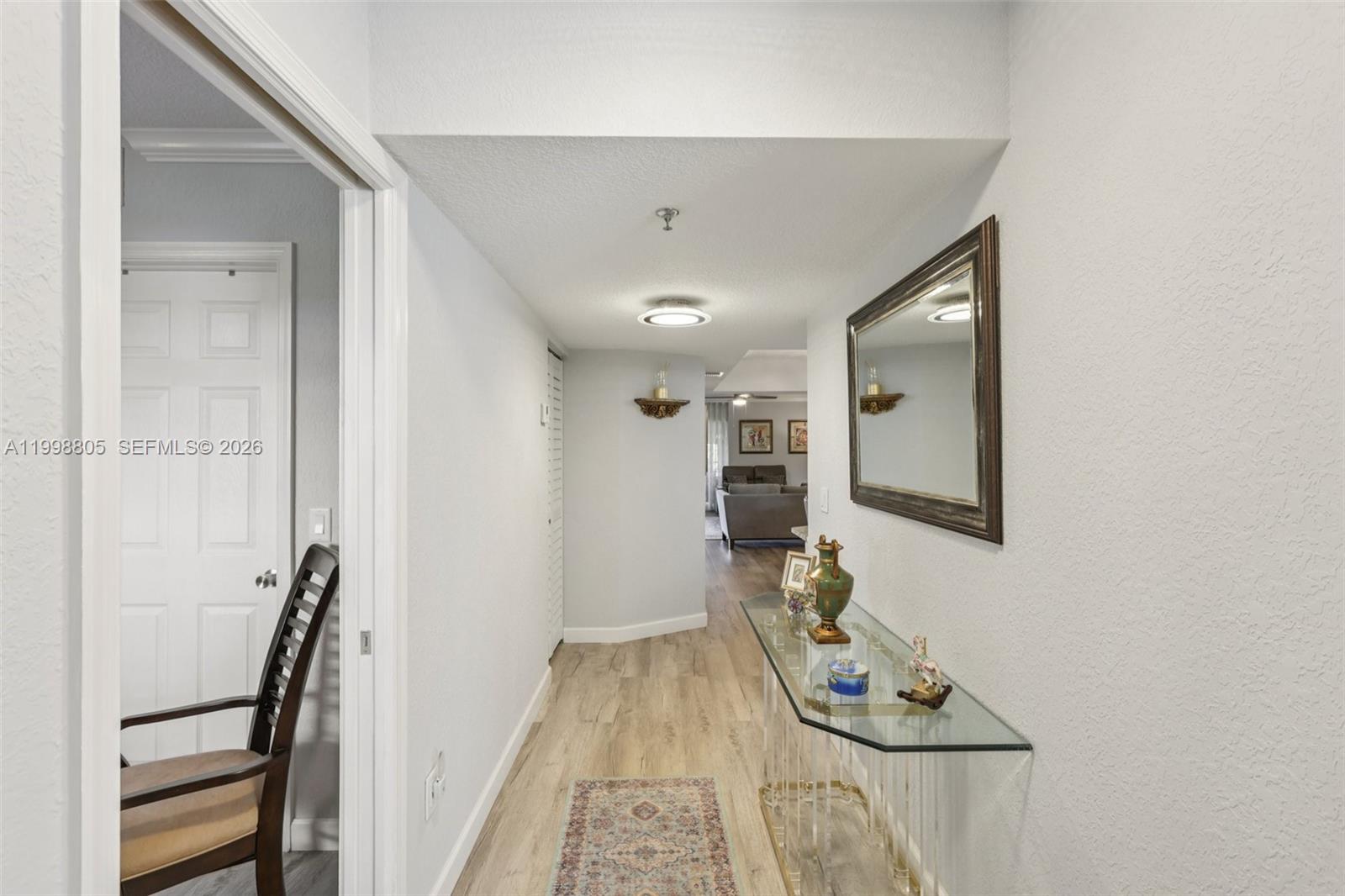 9170 Southwest 14th Street, Unit 4508 Boca Raton, FL 33428 - Photo 18 of 48 a hallway with furniture and wooden floor
