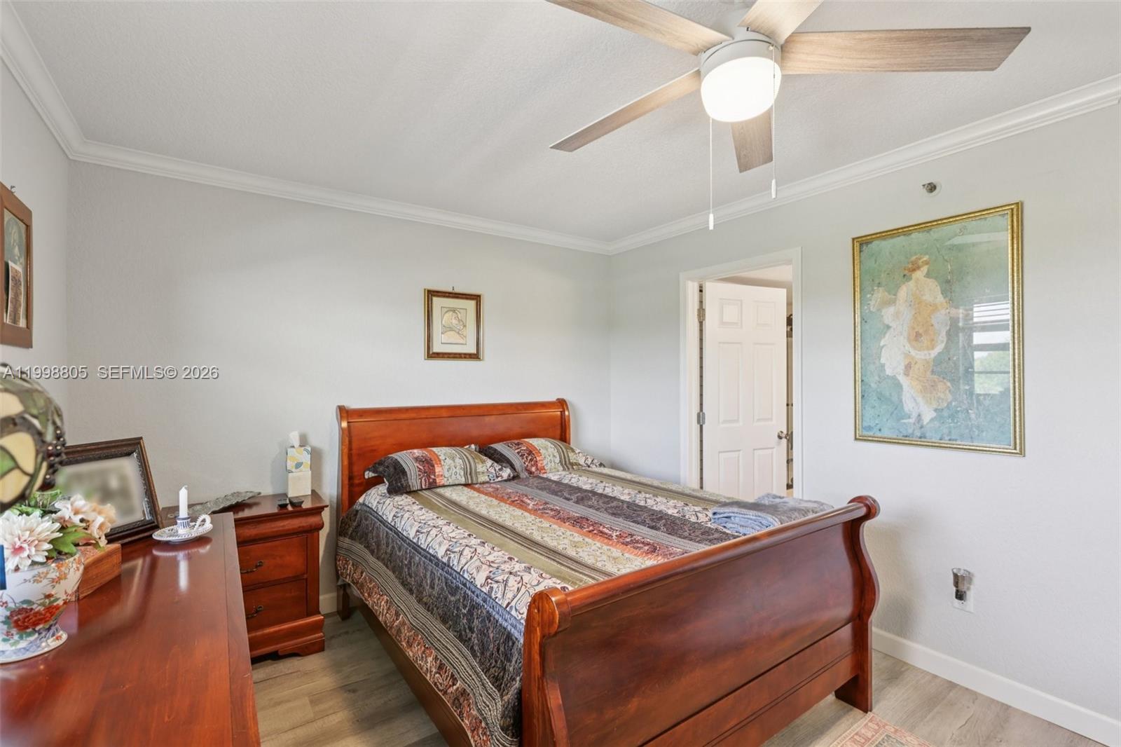 9170 Southwest 14th Street, Unit 4508 Boca Raton, FL 33428 - Photo 21 of 48 a bedroom with a bed and a chandelier