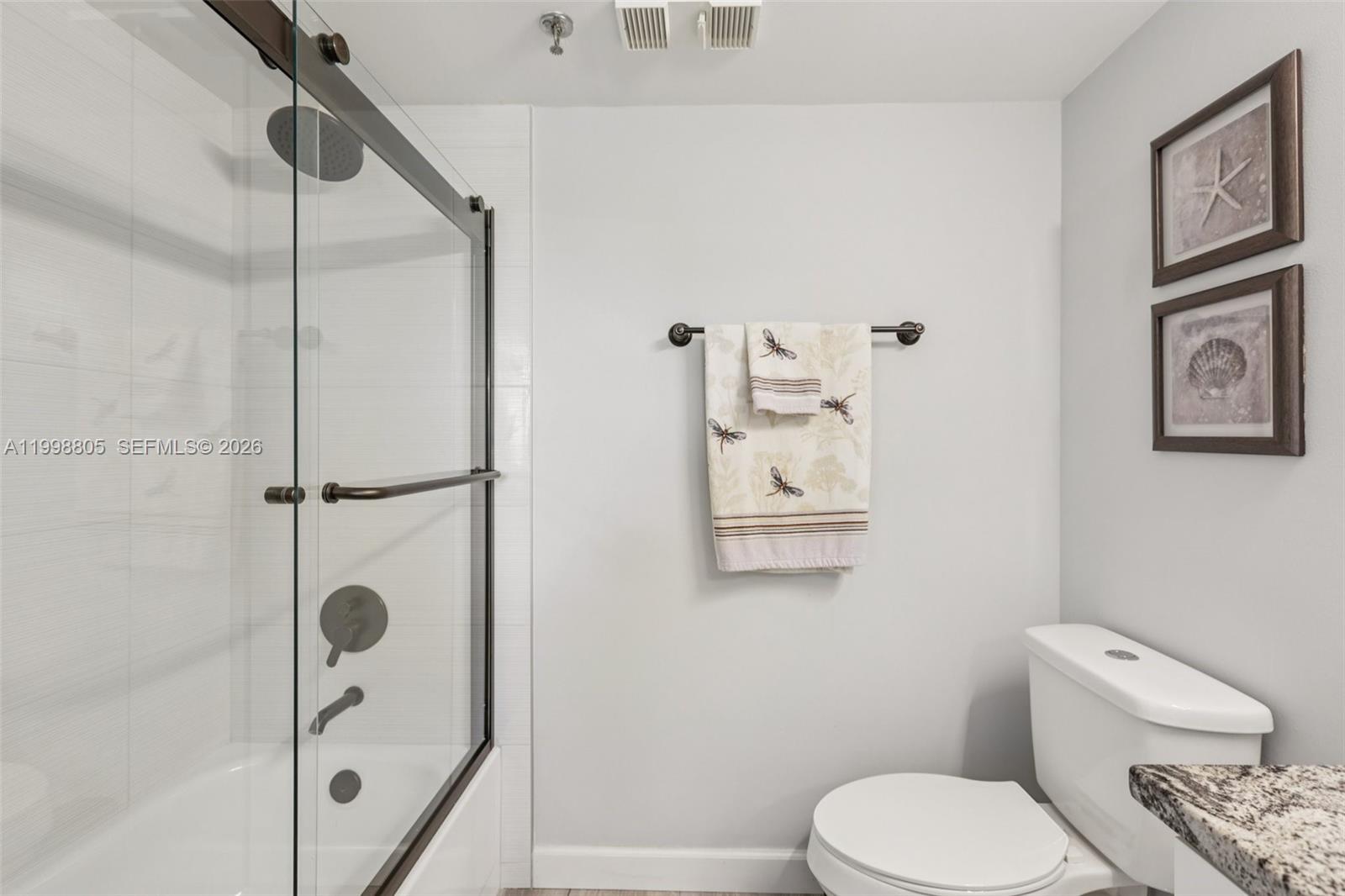 9170 Southwest 14th Street, Unit 4508 Boca Raton, FL 33428 - Photo 24 of 48 a bathroom with a toilet and a shower