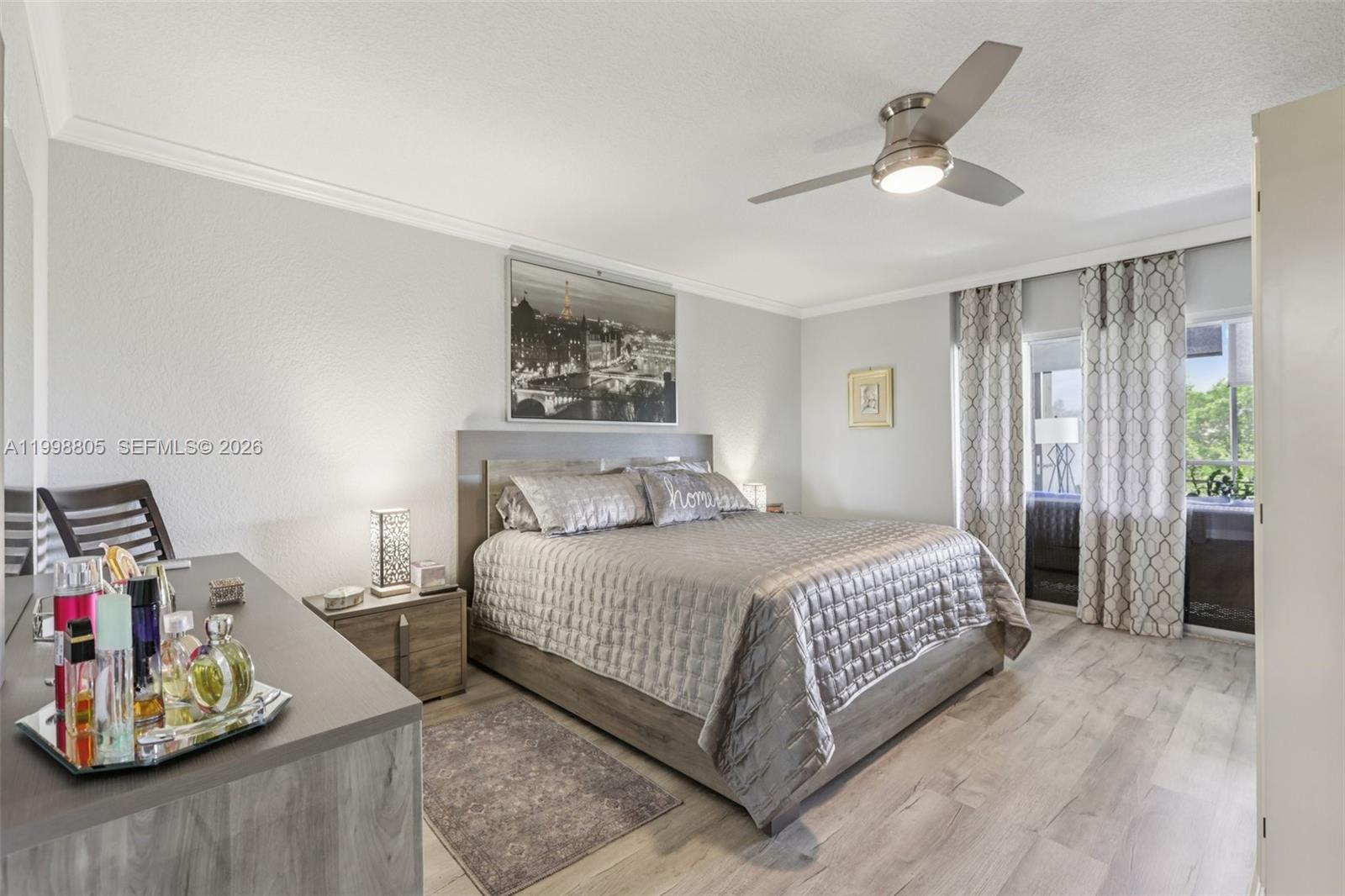 9170 Southwest 14th Street, Unit 4508 Boca Raton, FL 33428 - Photo 27 of 48 a bedroom with a bed and a chandelier