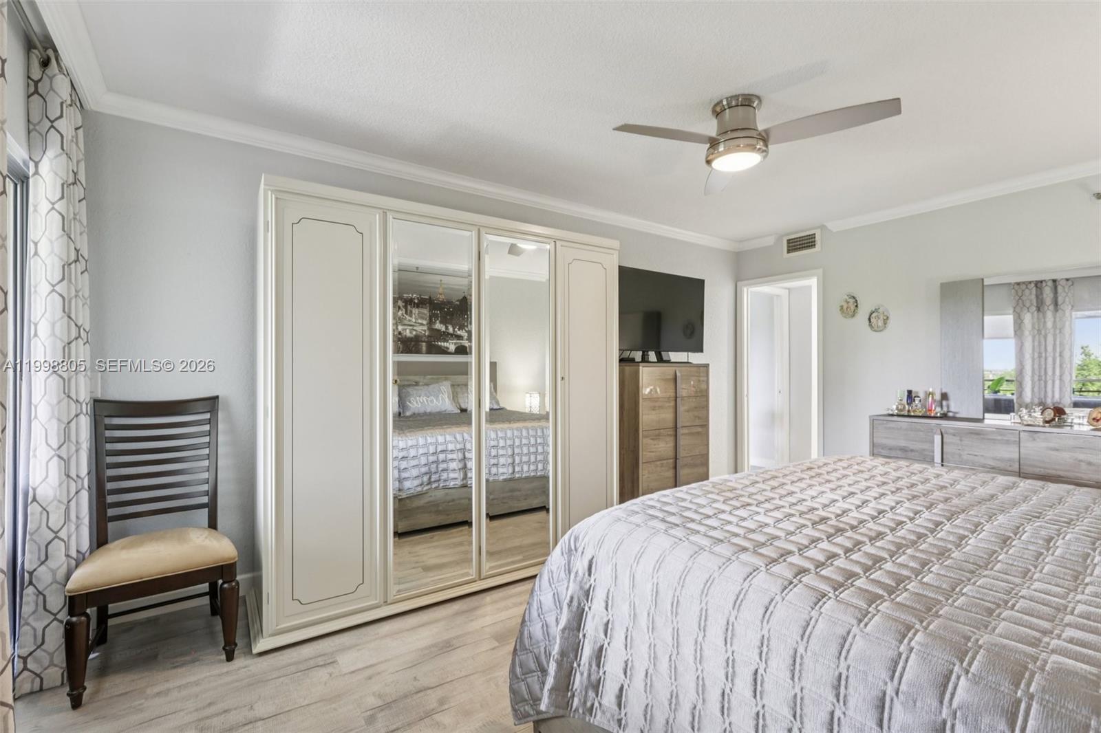 9170 Southwest 14th Street, Unit 4508 Boca Raton, FL 33428 - Photo 29 of 48 a bedroom with a bed and a chair