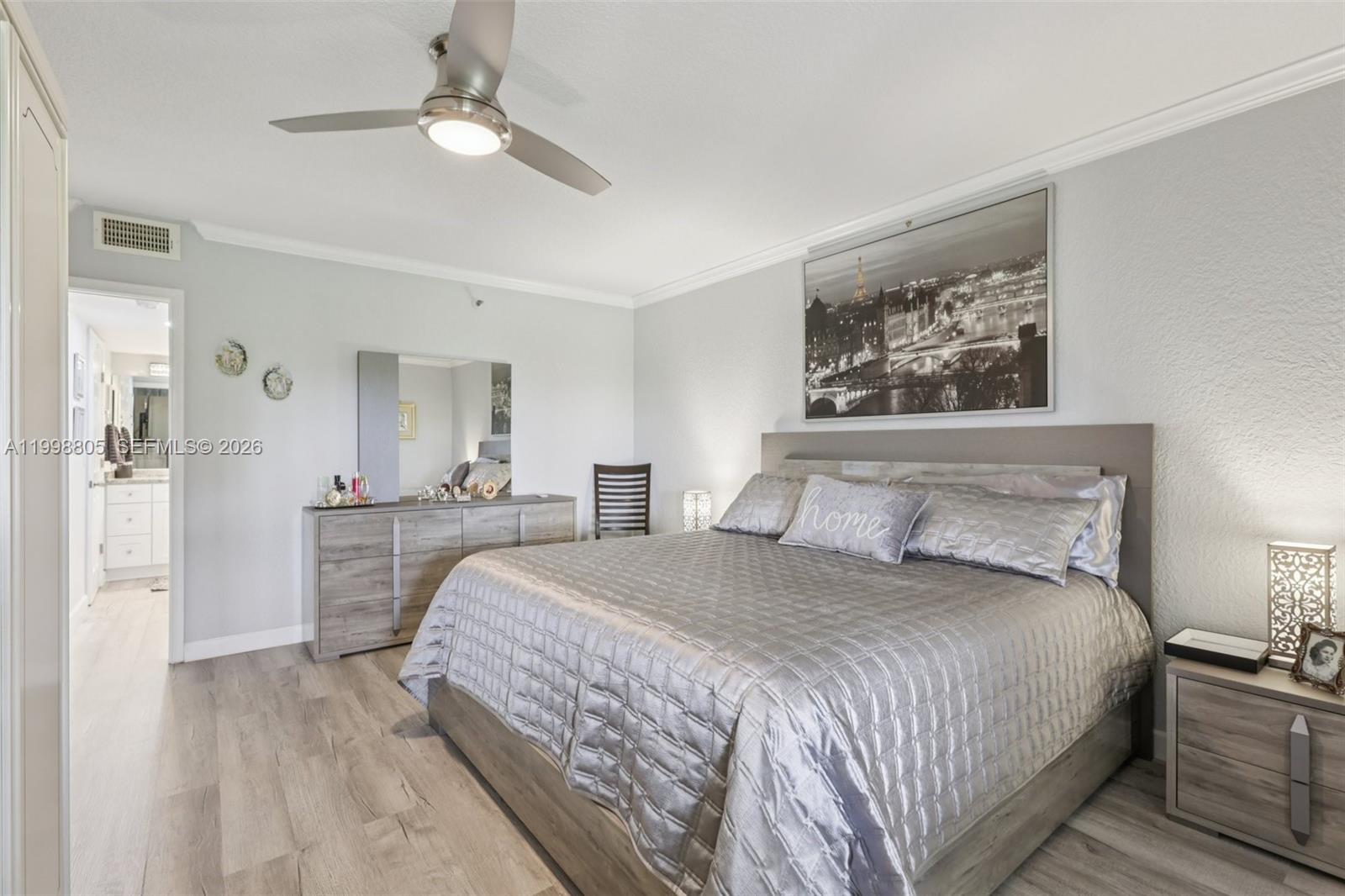 9170 Southwest 14th Street, Unit 4508 Boca Raton, FL 33428 - Photo 30 of 48 a spacious bedroom with a bed and a chandelier