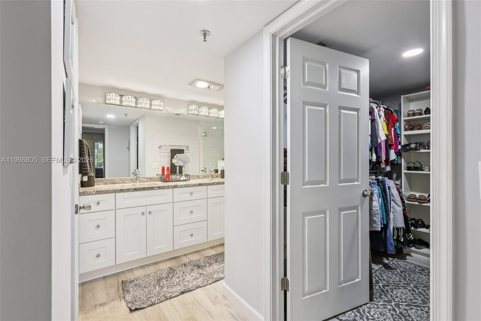 9170 Southwest 14th Street, Unit 4508 Boca Raton, FL 33428 - Photo 31 of 48 a spacious bathroom with a shower a sink and a mirror