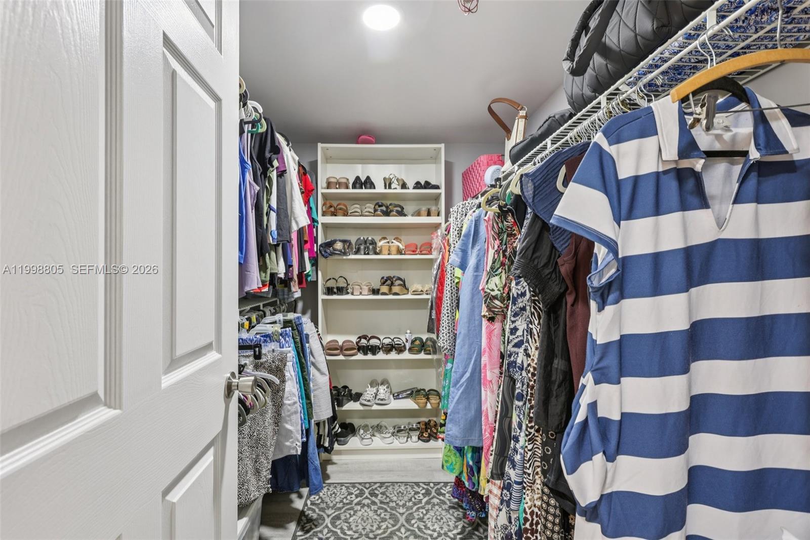 9170 Southwest 14th Street, Unit 4508 Boca Raton, FL 33428 - Photo 32 of 48 a view of walk in closet with clothes
